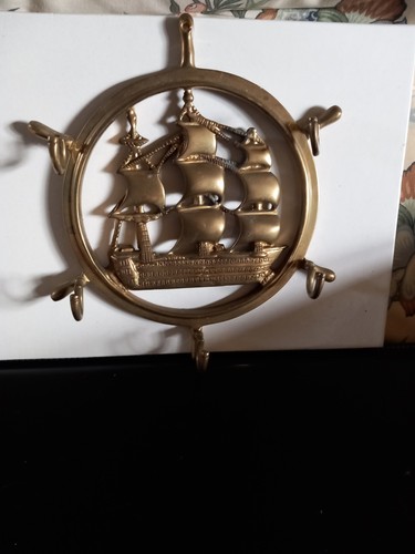 Brass ship wheel with - a,