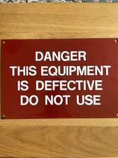 Red enamel warning sign with white lettering.