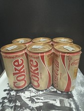 A group of unopened cans of Coke (some leaking)