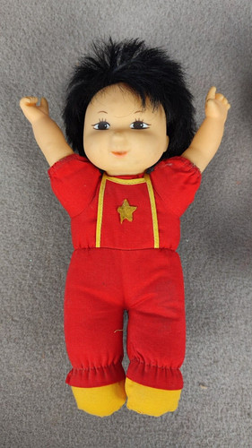 Doll hands the world - up, in