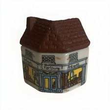 A Wade Whimsey-on-Wye figurine of an antique shop.
