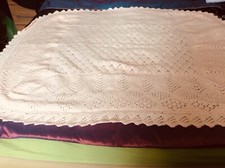 Hand knitted baby shawl in double knit baby wool.