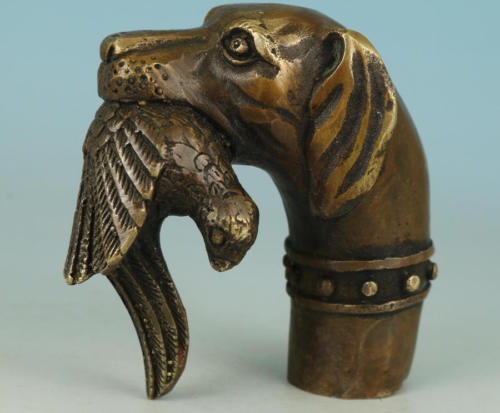 Old bronze hand carved dog - hand,