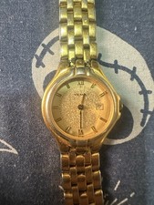 gold-tone Yema quartz watch with a textured dial and date window