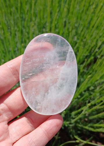Clear calcite crystal - , palm