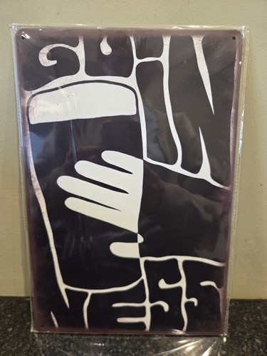 Guinness tin sign man - man, cave