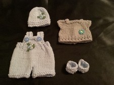 Hand knitted dolls clothes to