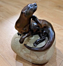 Otter on rock bronze sculpture