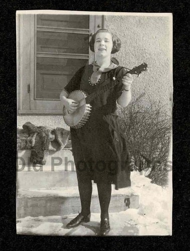 Woman playing banjo - playing, coat