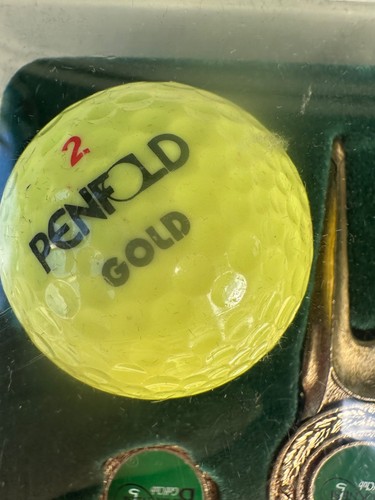 Penfold gold golf - ball, tee