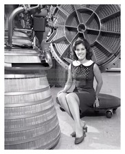 MISS NASA SMILING NEXT TO APOLLO ROCKET ENGINE 1968 8X10 PHOTO