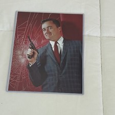 Robert Vaughn holding gun from