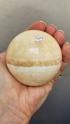 Orange banded calcite sphere - banded,