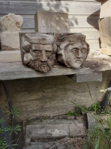 Old pair stone heads - stone,