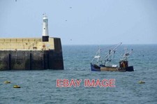 PHOTO  RETURNING TO PORT A FISHING BOAT RETURNING TO THE SAFE HAVEN OF PEEL HARB