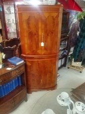 A reproduction yewwood cocktail cabinet with mirrored draw