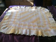 Hand knitted baby shawl in baby marble double knit wool.
