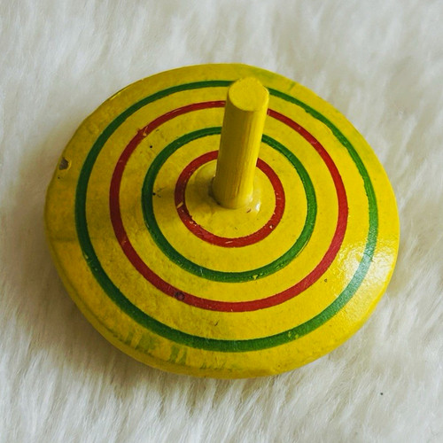Yellow wooden spinning top - spinning,