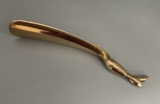 SECOND HAND BRASS TONE METAL SHOE HORN WITH FINIAL FORMED AS A LADY'S LEG & BOOT