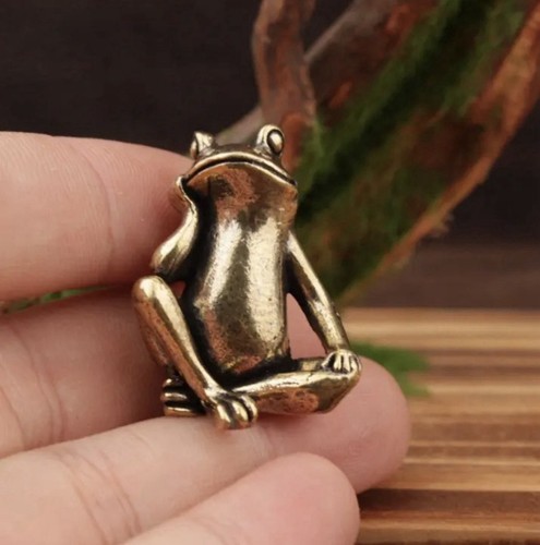 The brass statuette sitting - the,