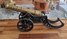 antique brass cannon and cast iron carriage