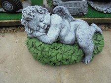 Cherub sleeping on a bed of