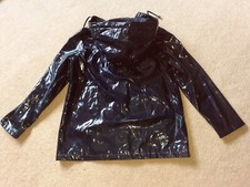 Vinyl mac. Glossy PVC pu. Large attached hood. Shiny and tactile. Zip front. 14