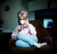 British singer Dusty Springfield relaxing on a chair drinking a cu- Old Photo