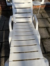 Used white plastic sun lounger