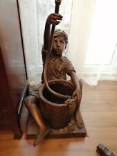 Bronze garden fountain depicting boy sitting by barrel