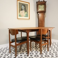 McIntosh Extending Teak Dining Table and Four Nathan Teak Chairs in Black Vinyl.