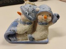 Snowman riding toboggan - snowman,