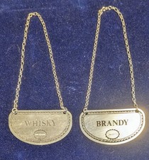 A pair of hallmarked sterling silver decanter labels made in England.